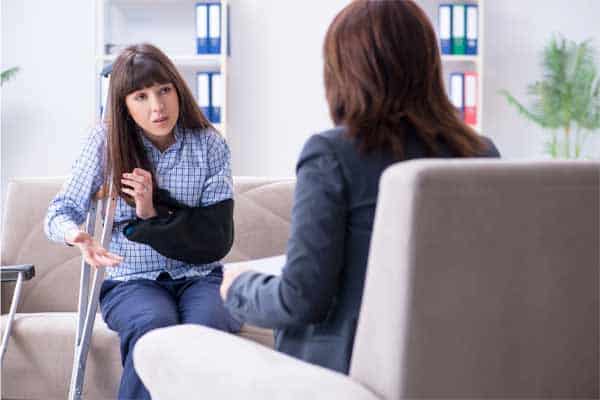 An injured woman meeting with an attorney.
