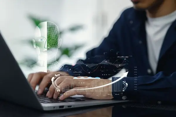 person typing on computer with ai coming off screen