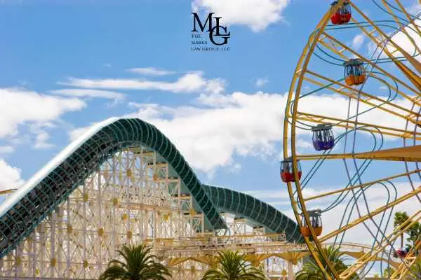 A wooden roller coaster and a Ferris wheel at an amusement park