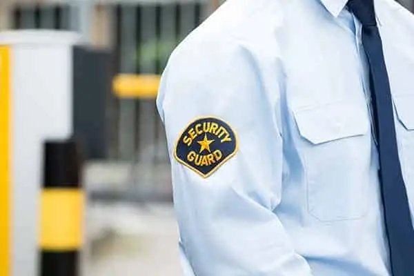 shoulder patch reading "security guard" on a light blue uniform shirt
