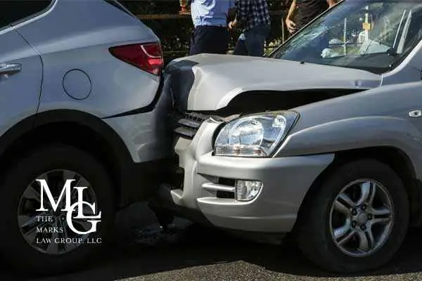 Front of a silver SUV crumpled into the rear bumper of another silver car
