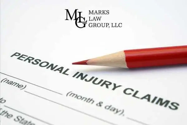 A personal injury claims form with a red pencil resting on it