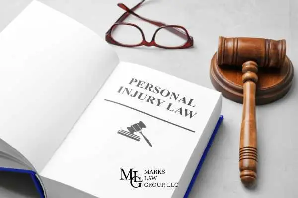 a book covering injury law statutes and a gavel on a white table