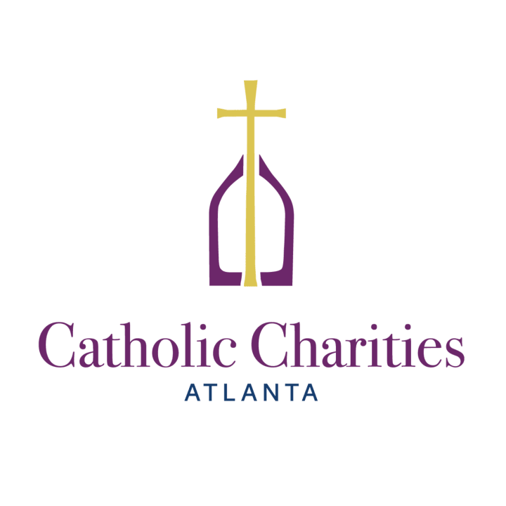 Catholic Charities Atlanta logo with a gold cross above a purple arch
