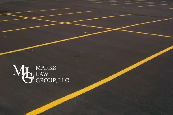 Empty asphalt parking lot marked out with fresh yellow bay lines