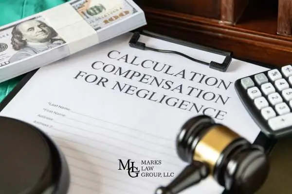 injury claim documents, money, and a gavel on a desk