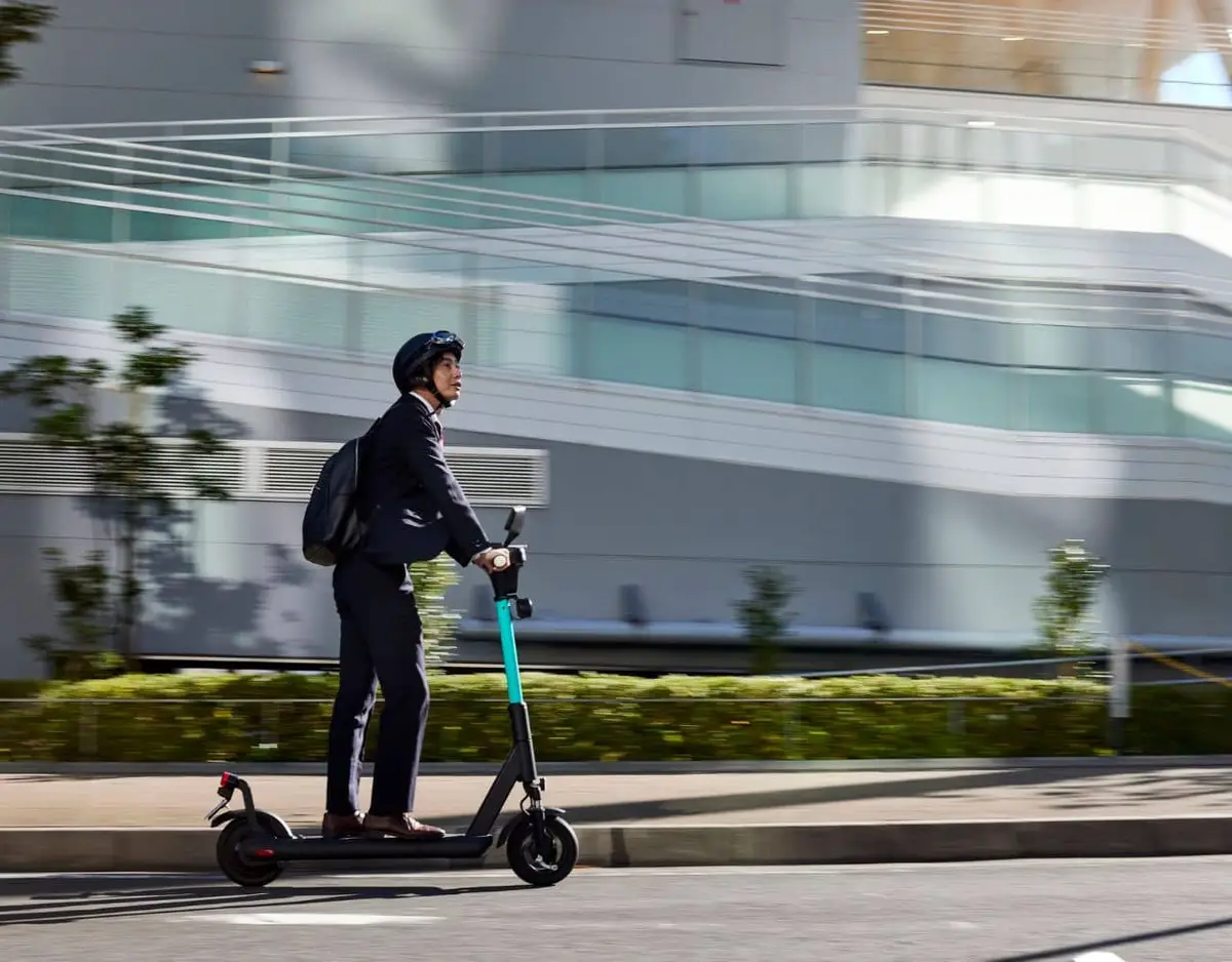 man riding on an e-bike with a helmet on