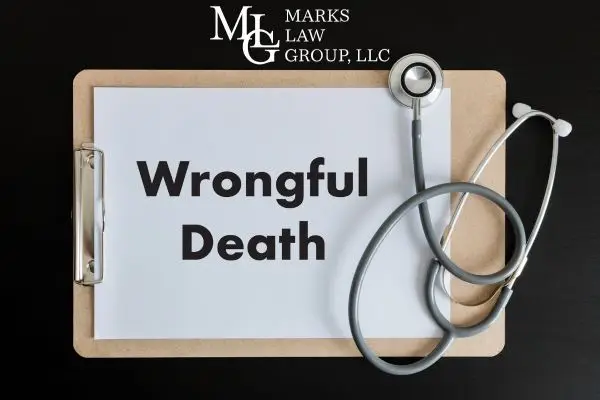 Clipboard with a sheet reading "Wrongful Death" and a stethoscope on a dark surface