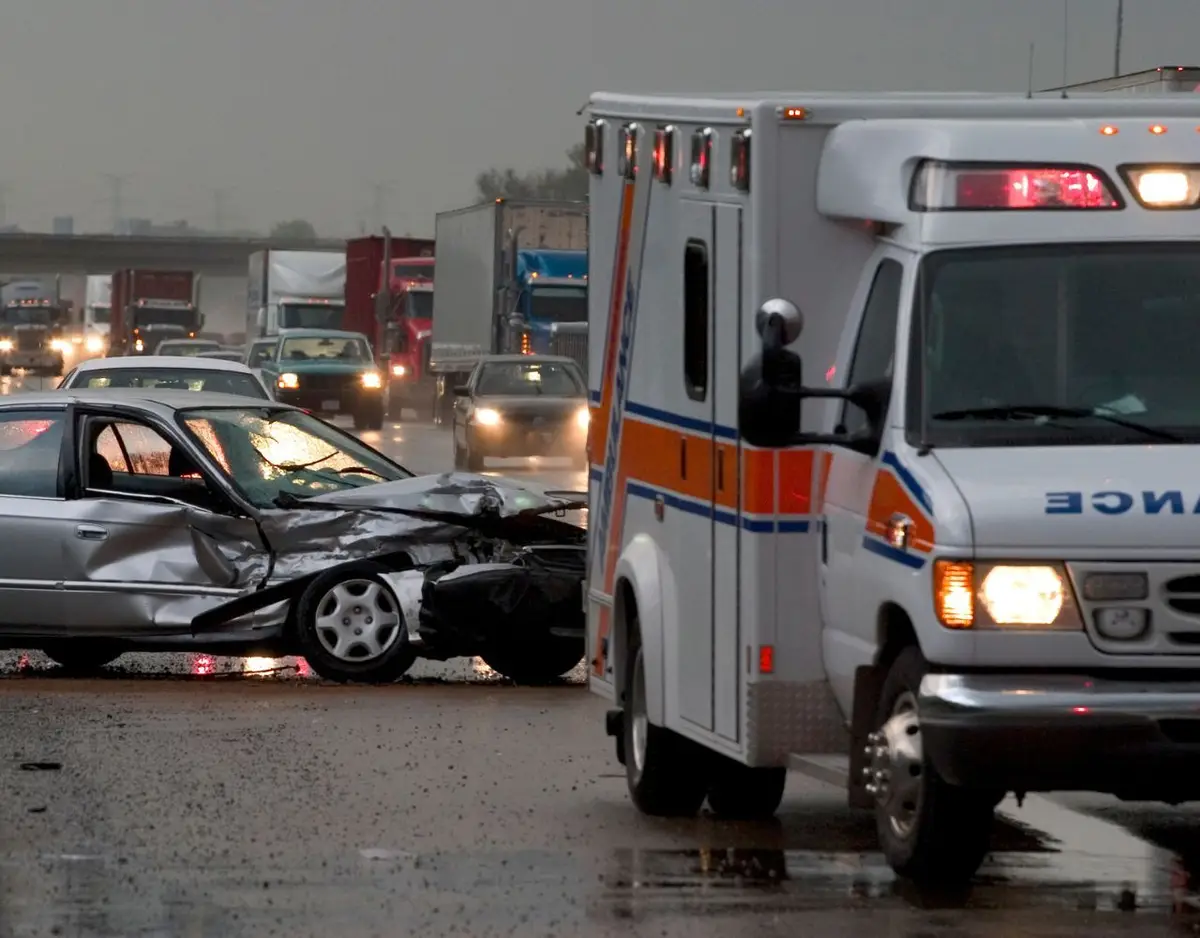 an ambulance at the scene of a car accident on an interstate