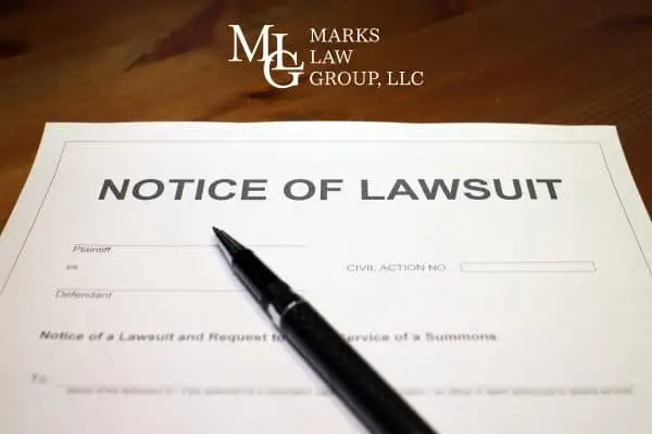 Notice of Lawsuit court form lying on a desk with a pen