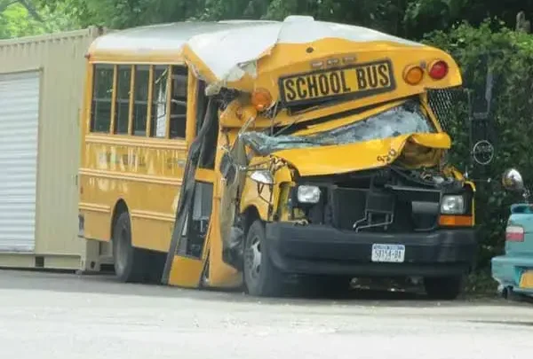 Yellow school bus with its front end crushed after a crash