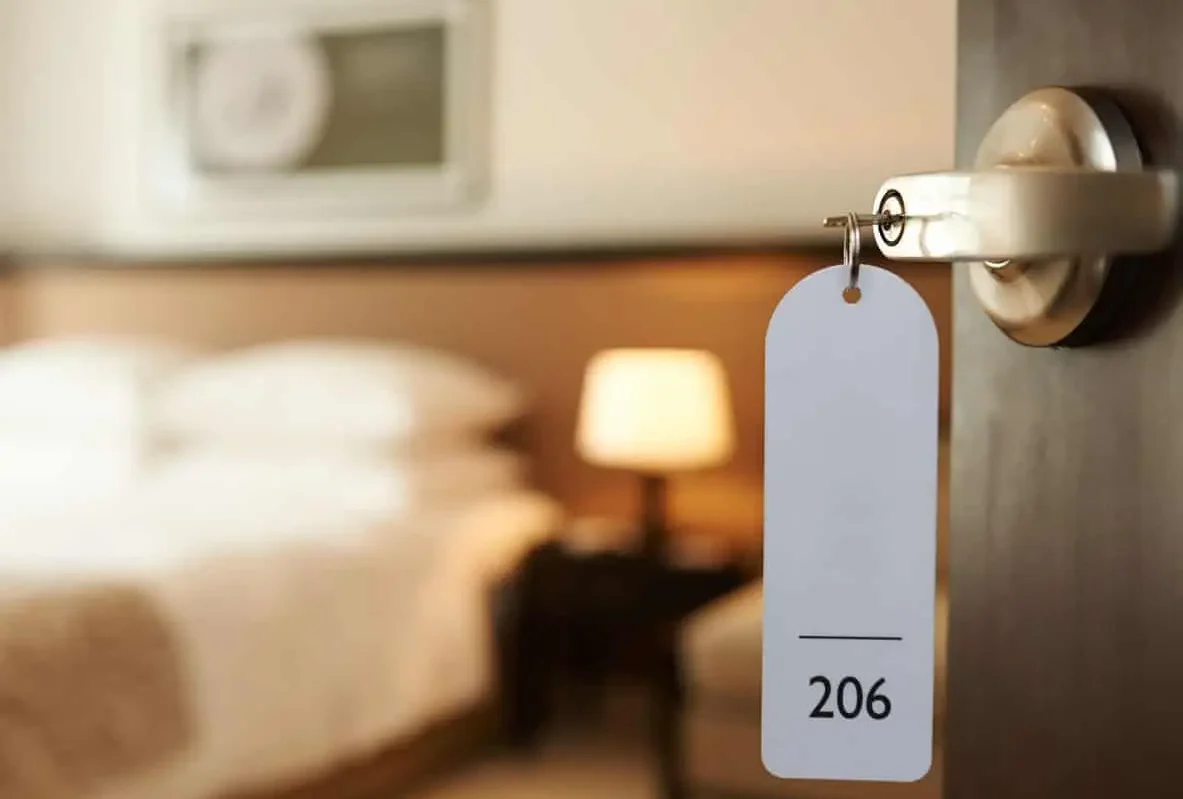 Hotel room key tag numbered 206 hanging in a door lock