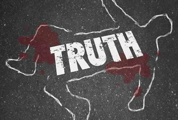 Chalk body outline with bloodstains and the word Truth on pavement