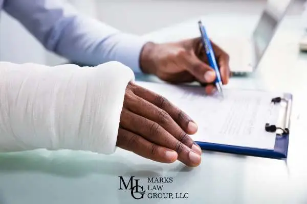a man with an arm in a cast filling out medical forms