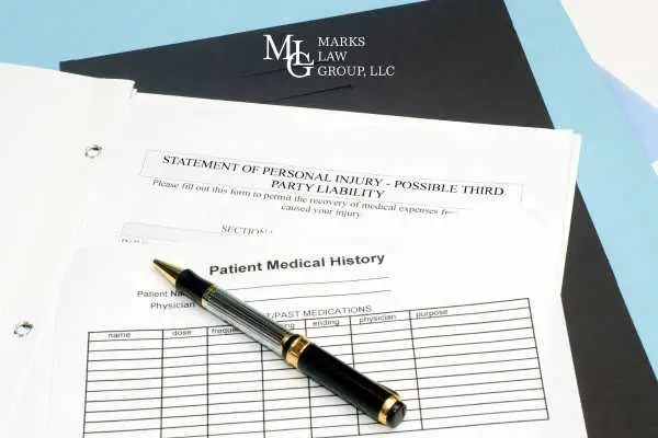 a patients medical history, folder, and pen on a table