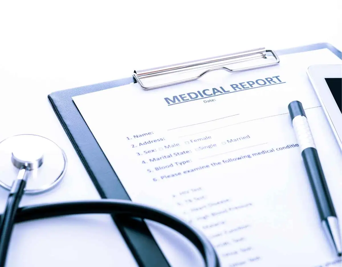 a pen, medical report, and stethoscope on a white background