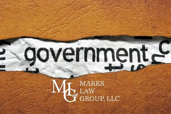 Torn brown paper revealing the printed word government underneath