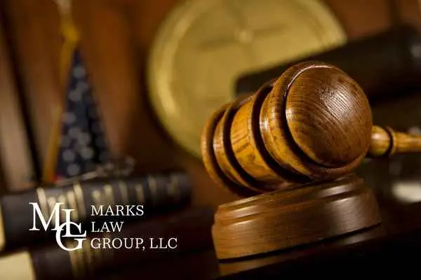 Wooden gavel resting on its block in a dim courtroom