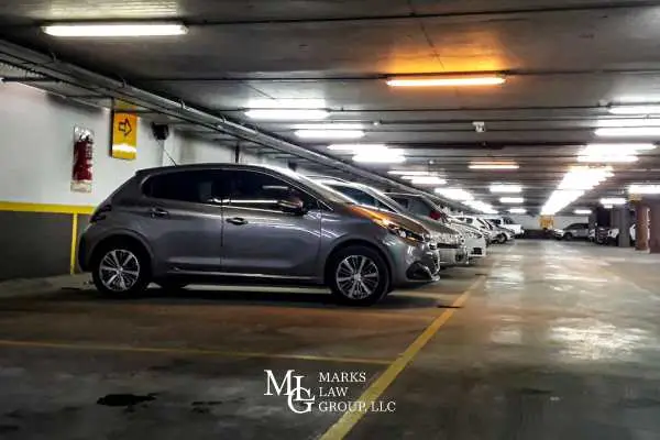 Cars parked in a row inside an underground parking garage