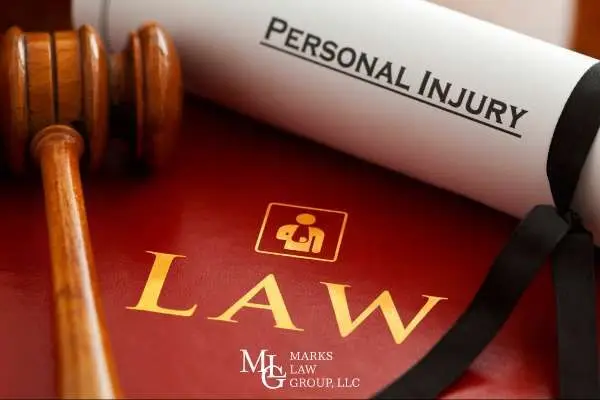 a gavel and a law book covering personal injury statues on a desk
