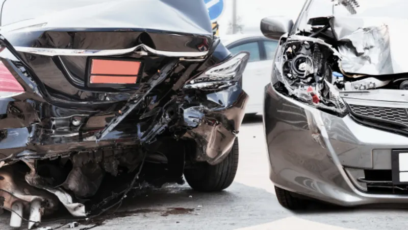 Two cars with crushed front and rear ends after a collision