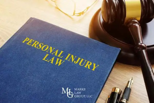 a desk with a book covering injury law and a gavel on it