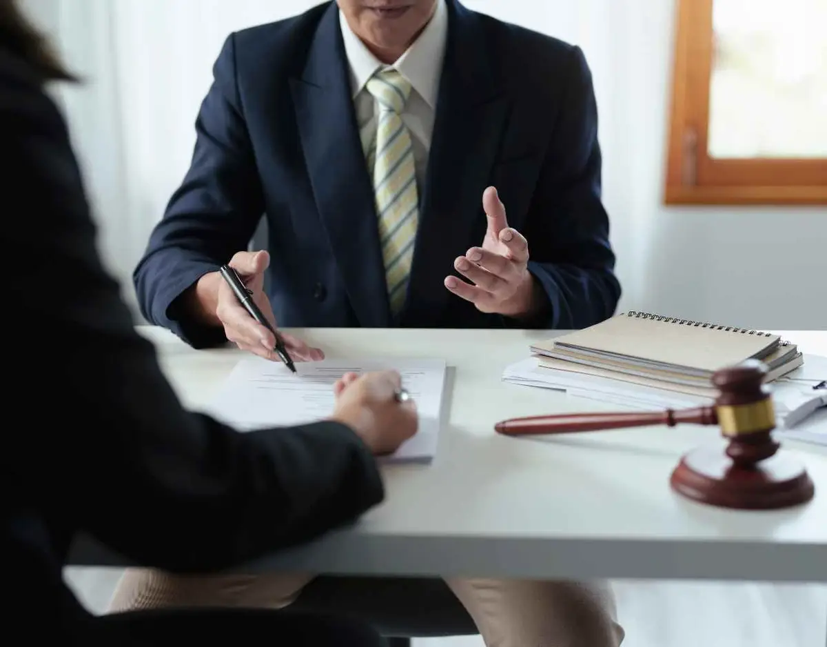 a woman meeting with an injury attorney to discuss a claim