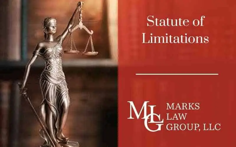 Bronze statue of blind Justice holding scales, beside the words Statute of Limitations