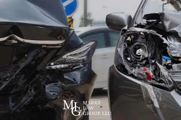 Two cars with crushed front ends after a head-on collision