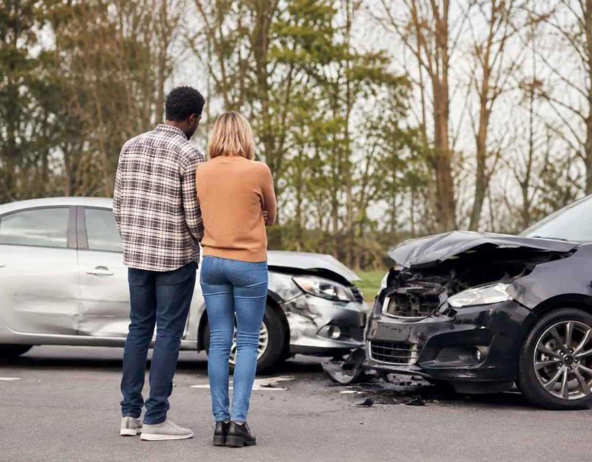 Two damaged cars after a Georgia traffic accident with drivers assessing the crash scene.