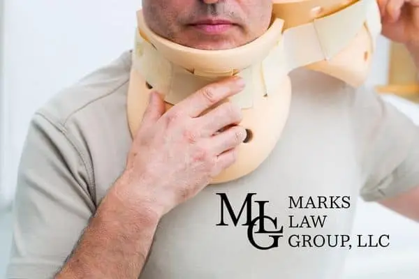 A man adjusting a rigid foam cervical collar around his neck
