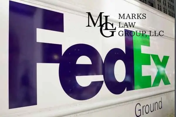 Close-up of a FedEx Ground delivery truck's side panel logo